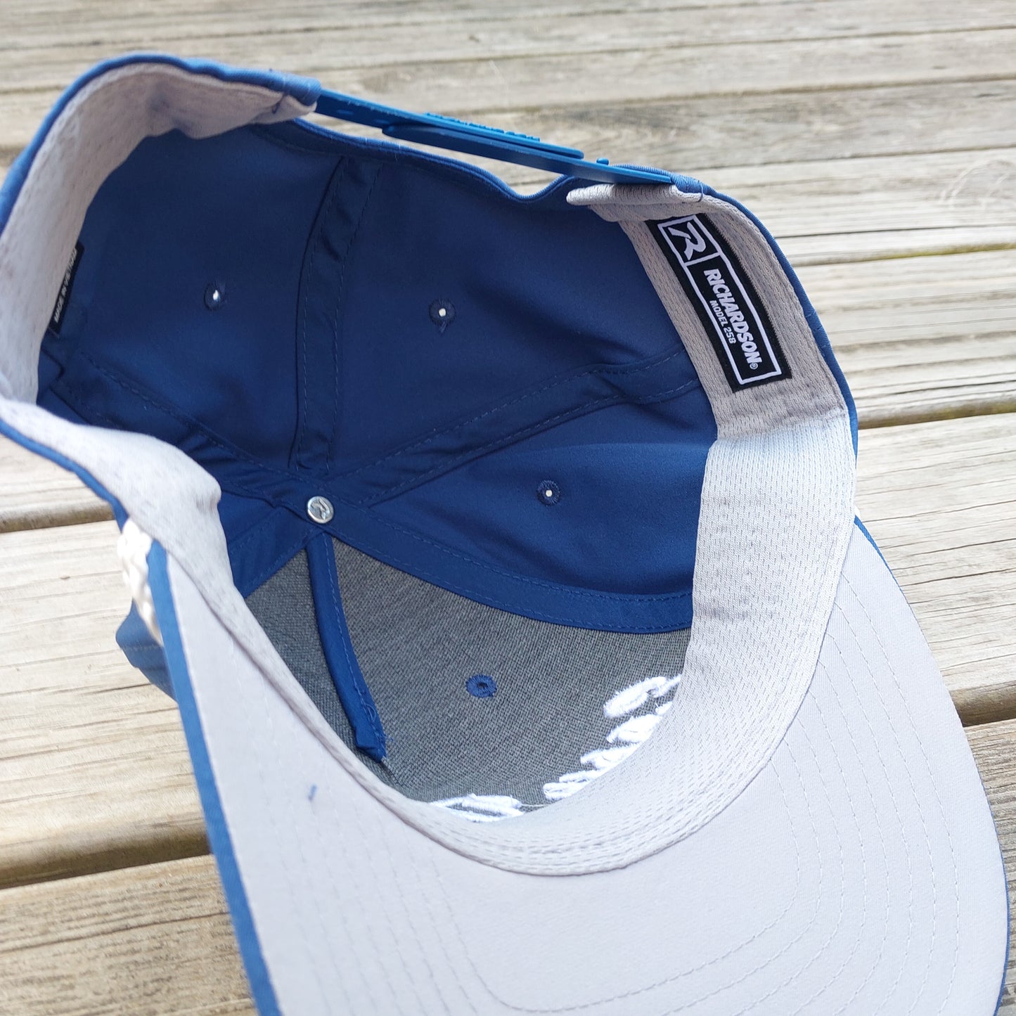 Easy Does It embroidered on a blue rope hat, under view