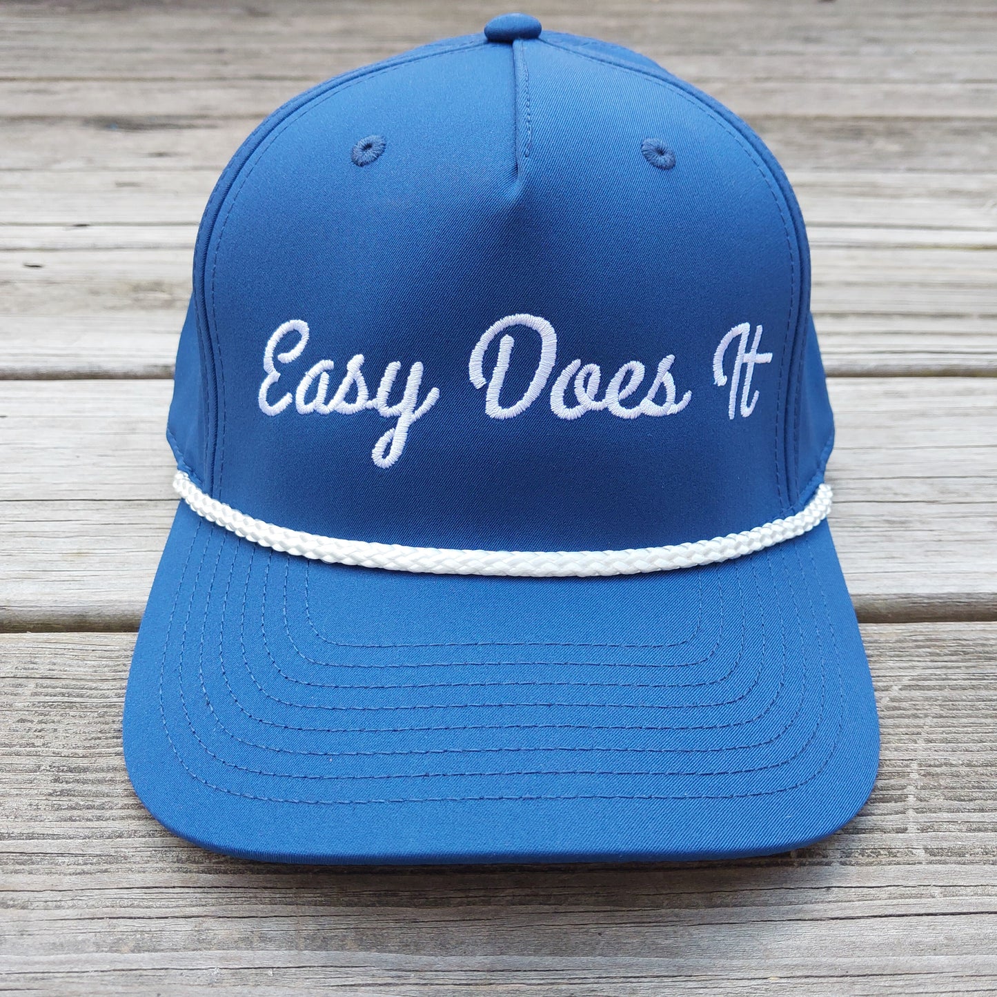 Easy Does It embroidered on a blue rope hat, front view