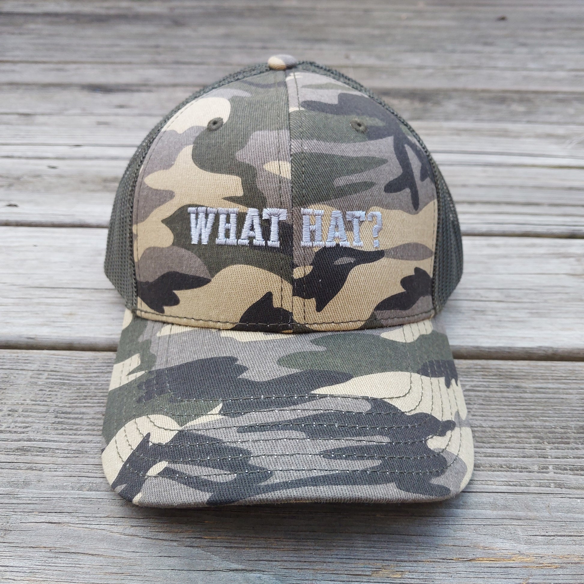 What Hat? embroidered on camo mesh trucker hat, front view